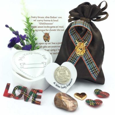 A delightful collection of Highland cow themed gifts and embellishments enclosed in a satin pouch with a trinket box and lucky sixpence. A quirky verse and sprig of heather plus a crystal stone completes this unique gift