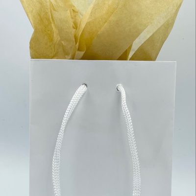 White gift bag with gold tissue